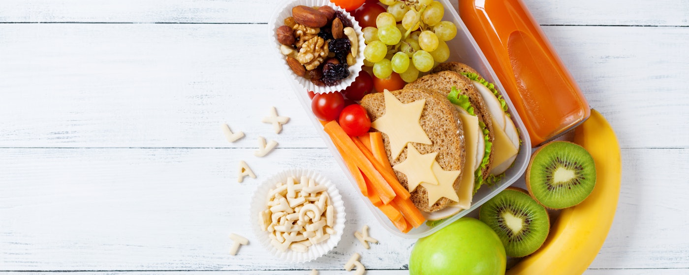 School lunch box with vegetables fruits and sandwich top view 1017725298